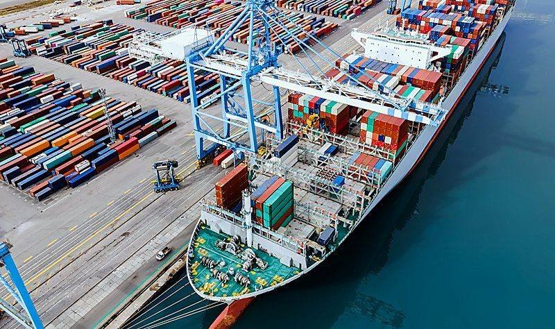 Aerial view of container port with cargo ship loading